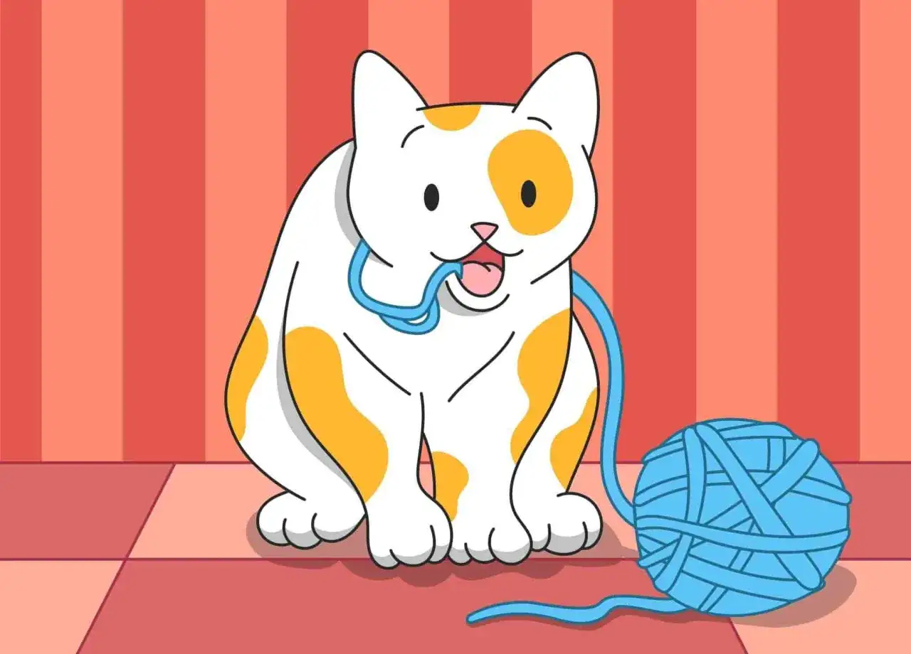Eine Katze mit orangefarbenen Flecken kaut auf einem blauen Wollfaden, ein mögliches Anzeichen für Pica Syndrom bei Katzen.